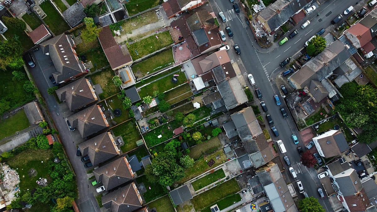 A view of the South East Wales property market, showing a mix of modern and traditional homes against a backdrop of green hills.